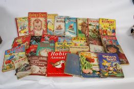 A collection of vintage annuals to include Rupert the Bear, Donald Duck, Treasure Island, Robin