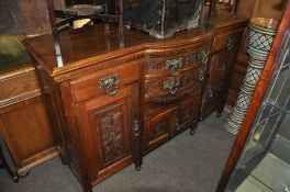 A late Victorian bow front walnut dresser base sideboard. Open arcade centre with bow front drawers