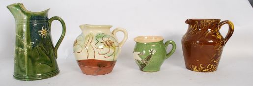 Four pottery jugs, one marked Union Instruementale Russin 1906 - 1926 height 22cm.