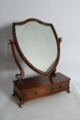 An Edwardian mahogany shield shaped dressing table toilet swing mirror with drawers to base.