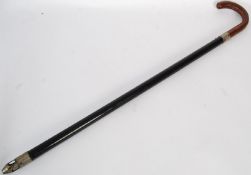 A mid 20th century torch walking stick cane with a hazelwood handle, ebonised shaft with bulb