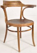 A 1920`s bentwood armchair in the manner of Thonet. Turned legs united by peripheral stretchers