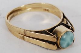 A 14ct gold reversable ladies ring with agat ston on bezel to one side, the reverse missing.