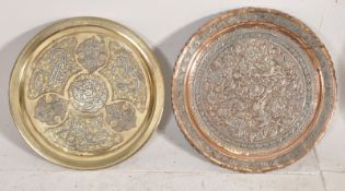 An islamic copper and silver inlaid tray with another asian copper and silvered tray decorated with