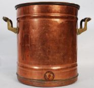 A large early 20th century copper urn having a ribbed cylindrical body, complete with lid and carry
