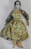 A 19th century porcelain headed doll with original clothing