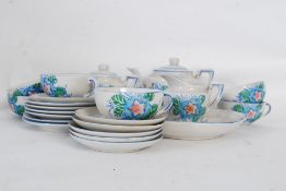 A vintage hand decorated childs china tea set in blue colouring.