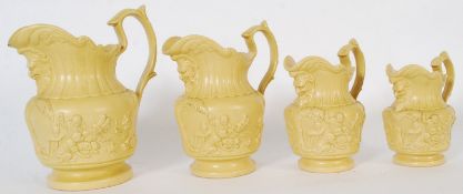 A set of 4 (possibly Copeland ) 19th century stoneware graduating figural head jugs in yellow, each