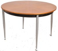 A 1970`s Merrow Associates Robert Young style teak and chrome dining table. The turned tapering