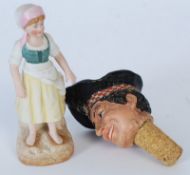 A 1950`s plaster head bottle stopper of a happy Scotsman together with a bisque figure of a girl