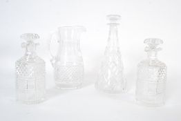 A 20th century crystal glass decanter along with a pair of other decanters and a large crystal jug.