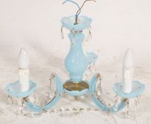 A vintage blue plastic chandelier set with crystal glass drops and fittings.