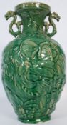 A mid 20th century Chinese Celedon oriental vase with twin temple dog handles, The body stylised