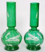 A pair of 20th century Mary Gregory style green glass vases. Bulbous bases reaching to ribbed stems