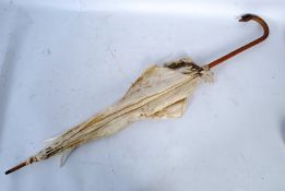 An Edwardian ladies parasol with silk embroidery parasol, carved cane with swan head zoomorphic