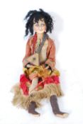 A vintage musical automaton doll in original clothing have wind out handle to the back, the doll