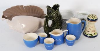 A collection of souvenir ware / mottoware to include a Dartmouth gurgling jug and a Poole pottery