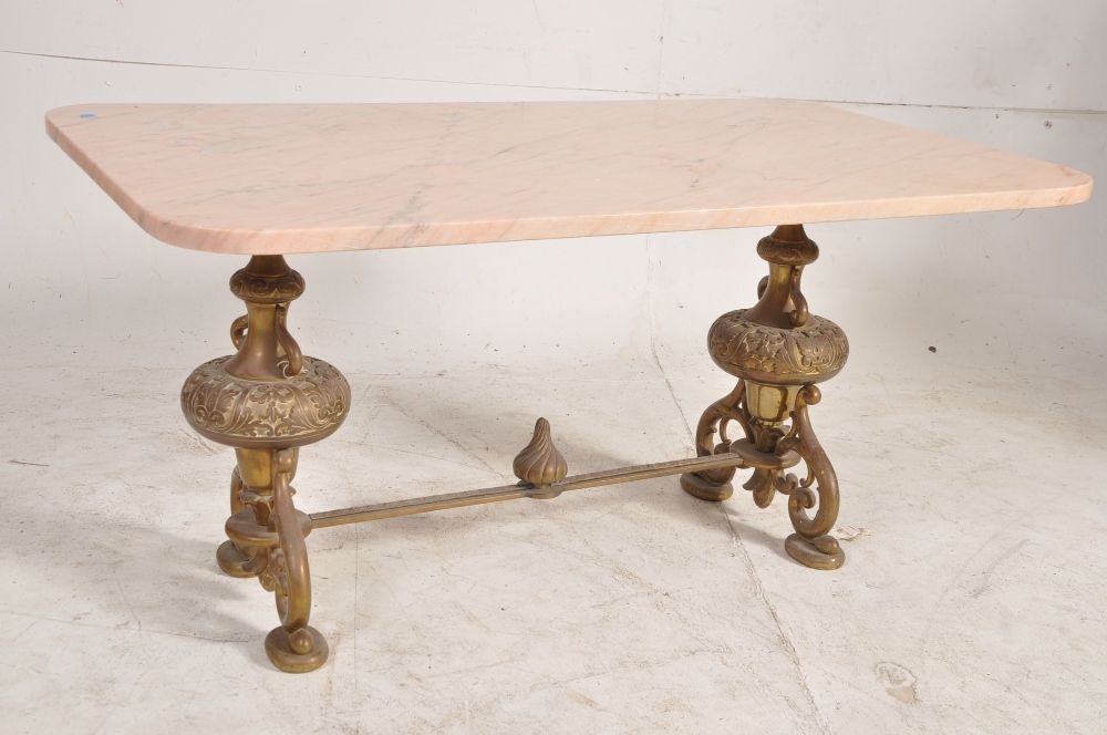 A 1950`s rococo brass and rouge marble coffee table. The heavily bulbous legs united by stretchers