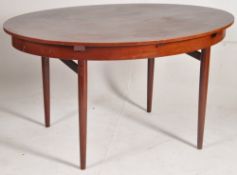 A retro 1970`s simulated rosewood extending dining table by Greaves & Thomas. Turned legs with oval