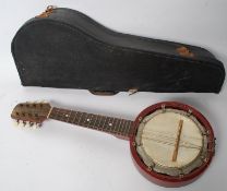 A vintage cased Banjolele instrument, with fretted neck and original lined case.
