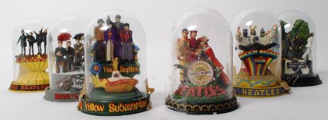 A set of 6 Franklin Mint figurines of The Beatles, each from a featured album artwork. Each figure