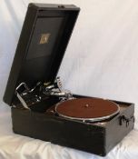 A vintage portable wind up HMV Gramophone, with label to inside and record mechanism to interior. In