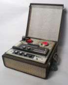 A portable Truvox reel to reel tape / music player. Speaker to front, and control knobs to top, in