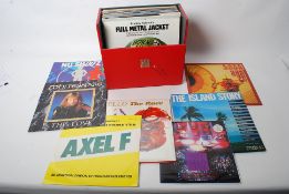 A collection of records and vinyl in a red carry case of 70's and 80's 12" records and LP's to