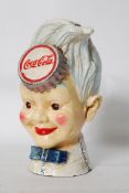 A retro Coca Cola advertising painted cast iron money box / collection box in the form of a soda