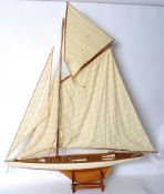 A good quality large pond yacht model of wooden construction having canvas sails and rigging. Raised