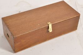 A mahogany campaign style box / trunk having hinged lid with inset brass handles to sides. The