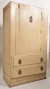 A 1930's Art Deco limed oak bachelors wardrobe. Shaped plinth  base with twin drawers under fitted
