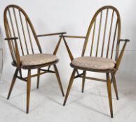 A pair of 1970's retro beech and elm carver armchairs. Turned legs united by stretchers having