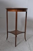 An Edwardian mahogany inlaid circular occasional table. Raised on square legs with circular top