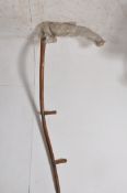 A vintage industrial farming scythe, with wooden handle and support handles