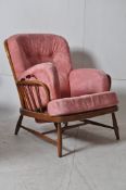 A 1970's beech wood Ercol armchair. Raised over turned supports united by  stretchers having a