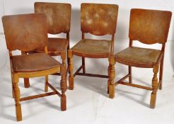 A 1940's set of 4 oak panel backed dining chairs. Turned wooden legs united by stretchers underneath