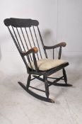 A vintage 20th century ebonised beech woood rocking chair. On sleigh runners with turned legs and