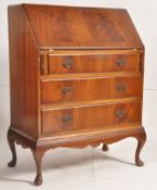 A 1930's Queen Anne revival walnut bureau raised on cabriole legs with 3 drawers under fall front