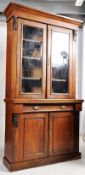 A Victorian walnut library bookcase display cabinet. Plinth base having cupboards and drawers