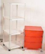 A modern industrial style bookcase on castor base with pierced upright supports together with a