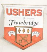 An original 20th century large enamel advertising sign of shield shape for Ushers of Trowbridge.