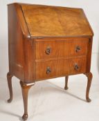 A 1930's Queen Anne revival walnut bureau raised on cabriole legs with 2 drawers under fall front