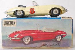 A vintage battery operated Lincoln International Toys e Type Jaguar car, in original box.