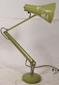 An original 1950's Herbert Terry anglepoise lamp in green. Circular base with pendant shape on