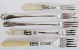 A good collection of pickle forks, two having mother of pearl handles, all of rococo form dating