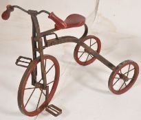 A cast iron miniature trike / teddys bike complete with wooden seat painted red