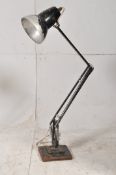 A Herbert Terry anglepoise lamp in black with a heavy cast base