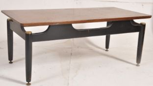 A 1960's G-Plan Librenza tola wood coffee table raised on ebonised supports with suspension effect