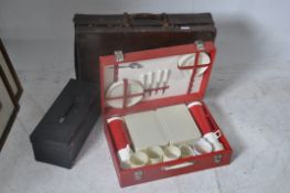 A vintage 1950's picnic hamper with contents together with a  vintage suitcase and a vintage music